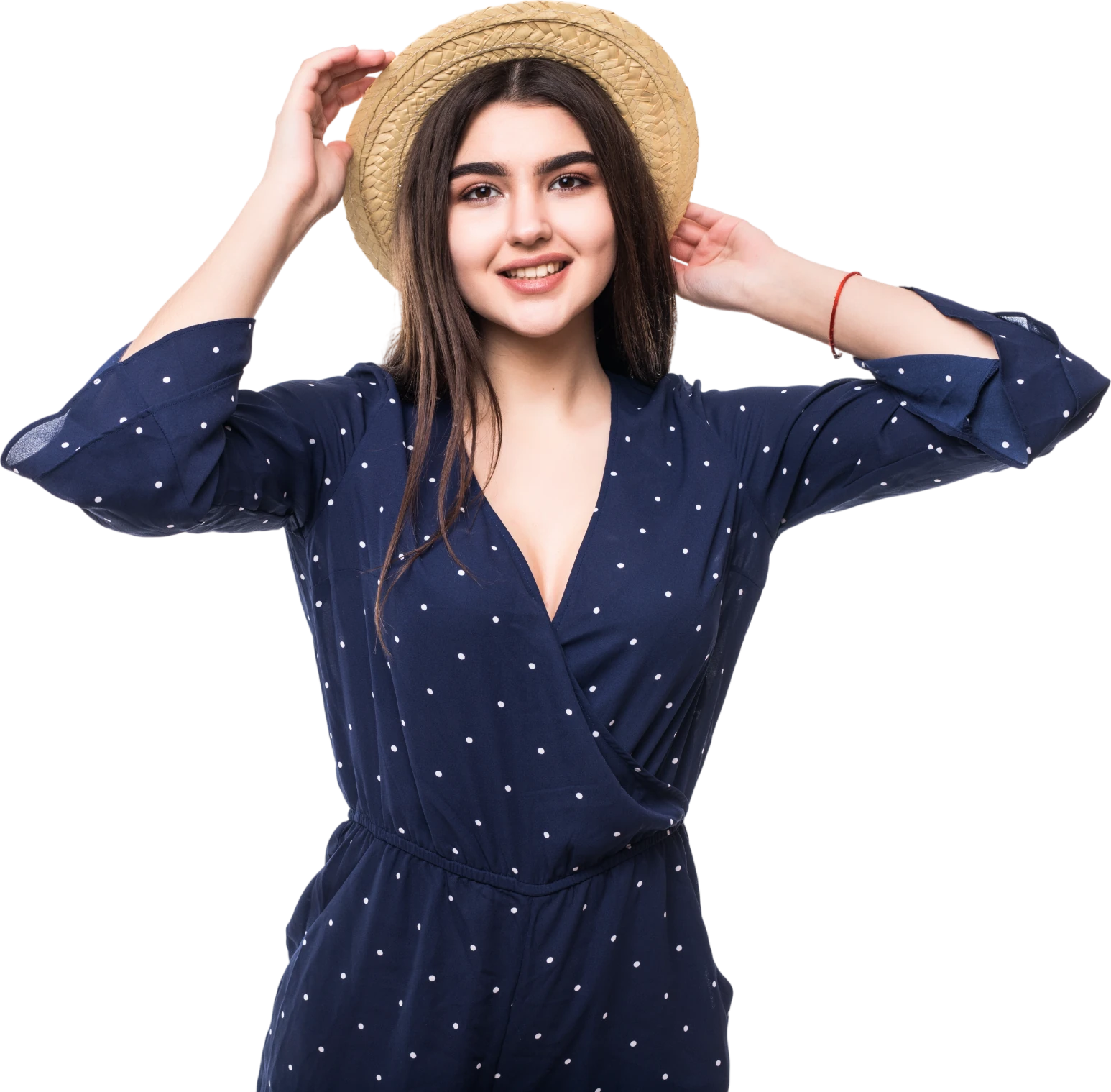 Smiling model in a straw hat and navy polka-dot jumpsuit, wearing the black square frames